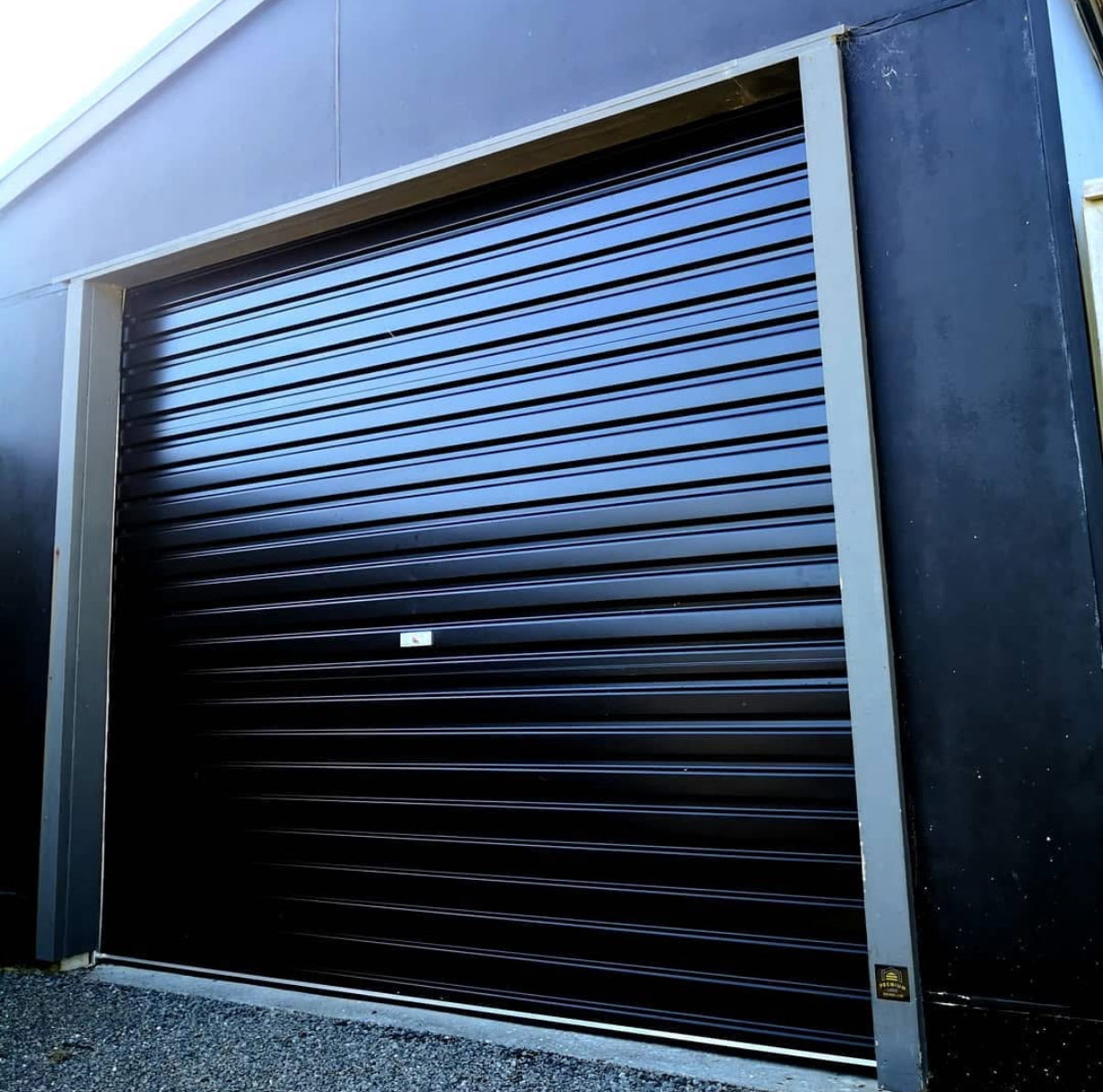 Black roller shutter door on a building exterior